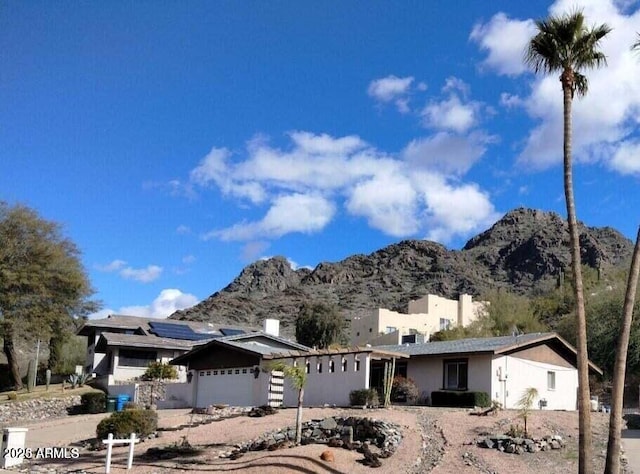 ranch-style house featuring an attached garage and a mountain view