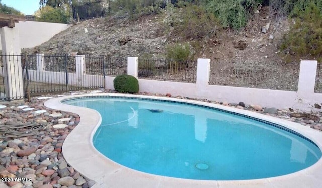 view of swimming pool with fence and a fenced in pool