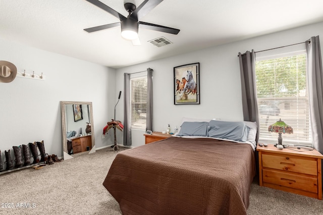 bedroom with visible vents, ceiling fan, and carpet