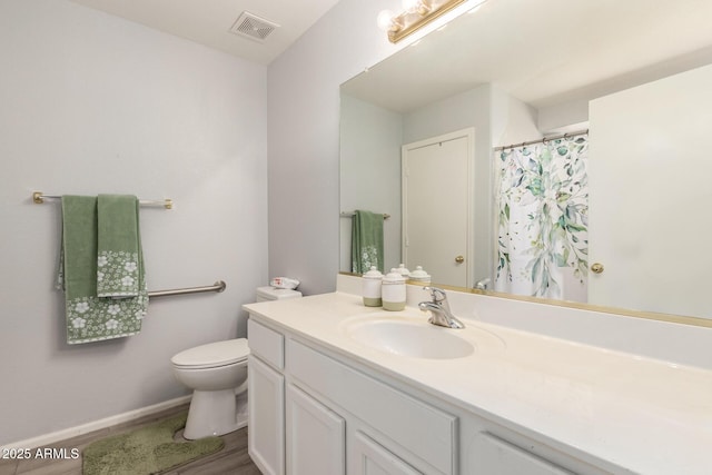 full bath with toilet, wood finished floors, vanity, and visible vents