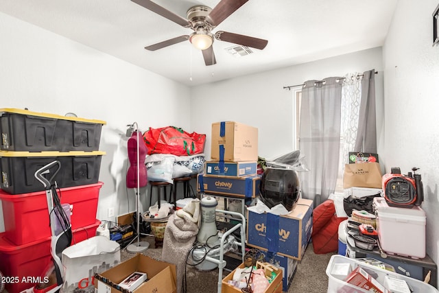 storage room featuring visible vents and a ceiling fan