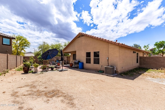 back of property featuring a patio area, a fenced backyard, cooling unit, and stucco siding