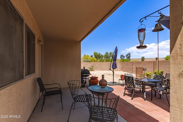view of patio / terrace with outdoor dining space and a fenced backyard