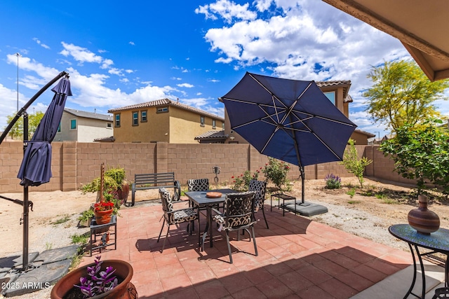 view of patio / terrace featuring outdoor dining space and a fenced backyard