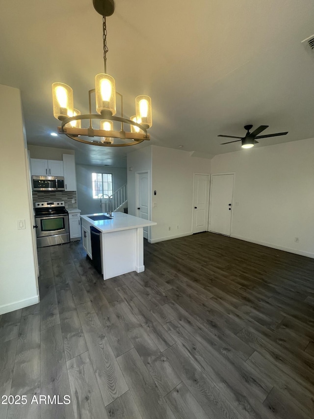 kitchen featuring sink, white cabinetry, a kitchen island, pendant lighting, and appliances with stainless steel finishes