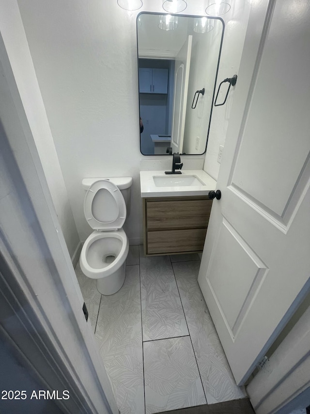 bathroom with toilet and vanity