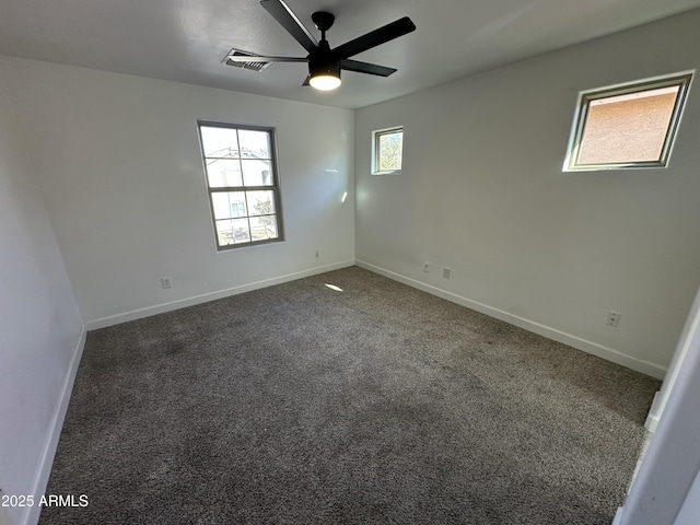 unfurnished room featuring dark carpet and ceiling fan