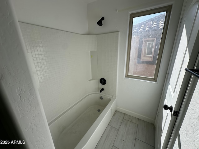 bathroom with tub / shower combination and plenty of natural light