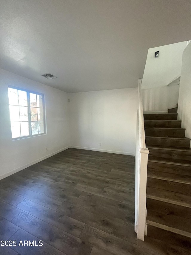 spare room with dark wood-type flooring