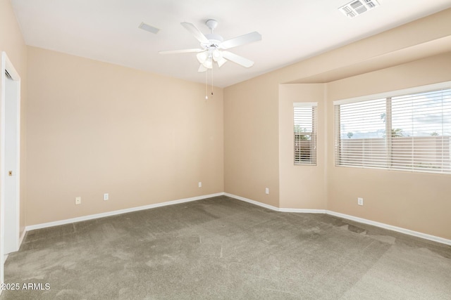 spare room featuring a ceiling fan, carpet flooring, baseboards, and visible vents