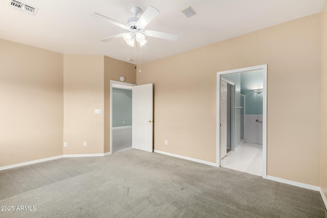 unfurnished bedroom with visible vents, light colored carpet, ensuite bathroom, and baseboards