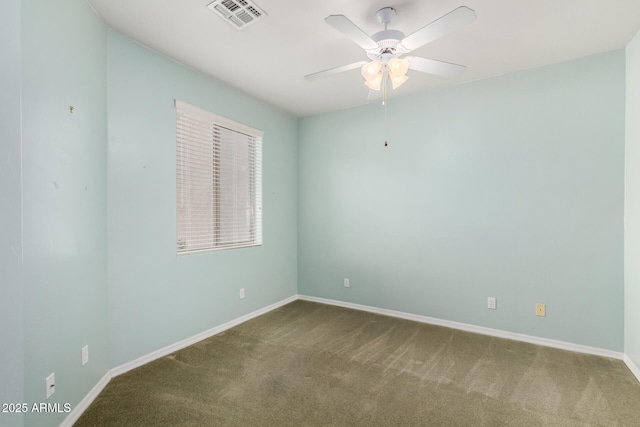 carpeted empty room with visible vents, ceiling fan, and baseboards