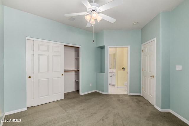 unfurnished bedroom with ensuite bath, a closet, carpet flooring, baseboards, and ceiling fan