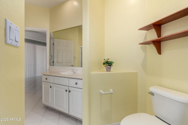 bathroom with tile patterned floors, toilet, and vanity