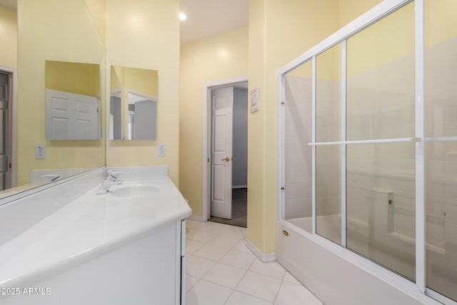 bathroom with tile patterned floors, baseboards, combined bath / shower with glass door, and vanity