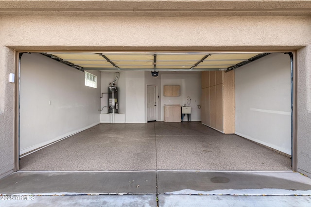 garage with strapped water heater, a garage door opener, and a sink