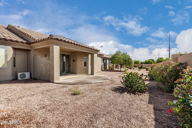 back of house with ac unit, stucco siding, fence, a patio area, and a tiled roof