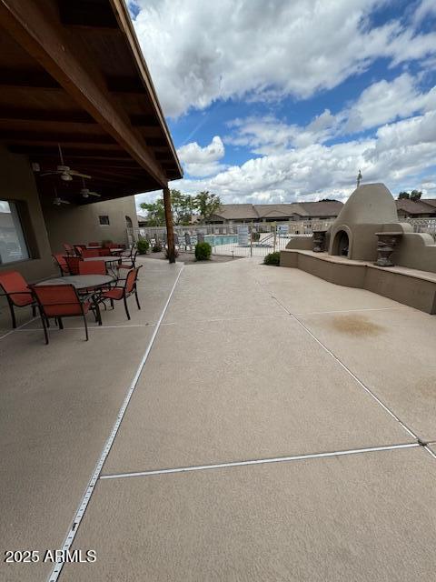 view of patio / terrace with fence and ceiling fan