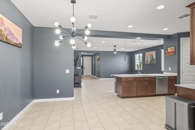 kitchen with light countertops, stainless steel dishwasher, a sink, and visible vents