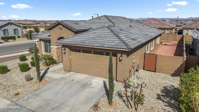 view of front of property with fence, driveway, a gate, a residential view, and stucco siding