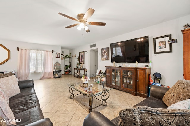 living area with light tile patterned flooring, a ceiling fan, and visible vents