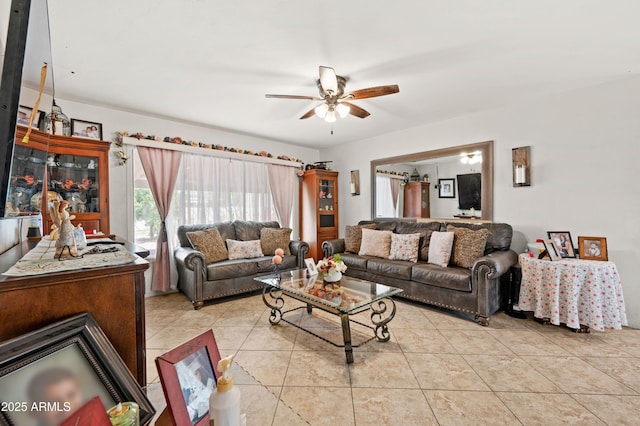 tiled living room with a ceiling fan