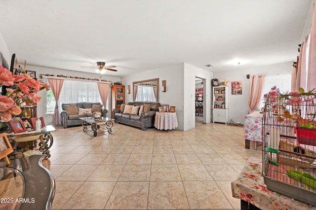 living area with light tile patterned floors, a ceiling fan, and visible vents