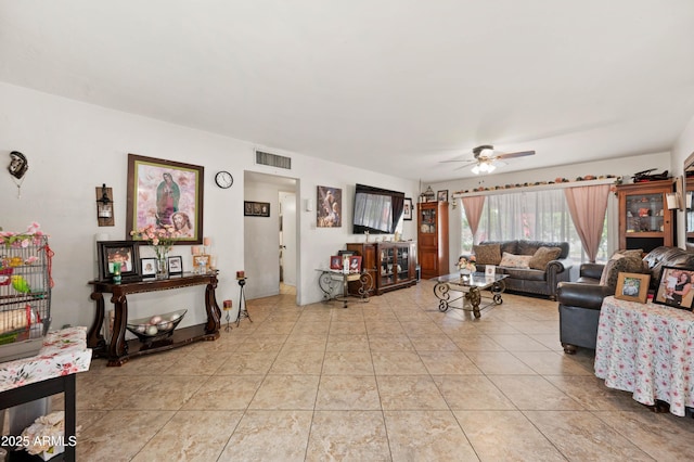 living room featuring visible vents, a ceiling fan, and light tile patterned flooring