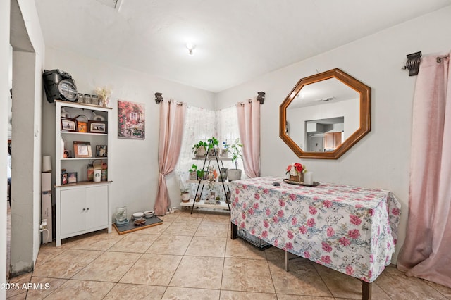 bedroom with light tile patterned floors