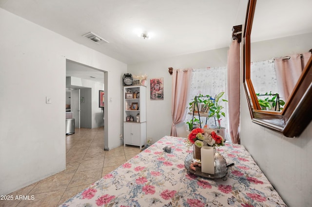 bedroom featuring visible vents and light tile patterned flooring