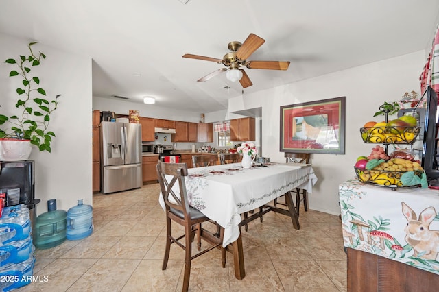 dining space with visible vents, ceiling fan, and light tile patterned floors