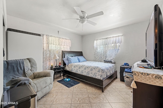 bedroom with light tile patterned floors and a ceiling fan