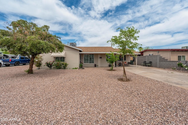 ranch-style house featuring fence