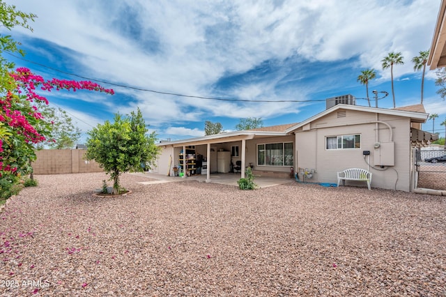 rear view of property featuring a patio area and a fenced backyard
