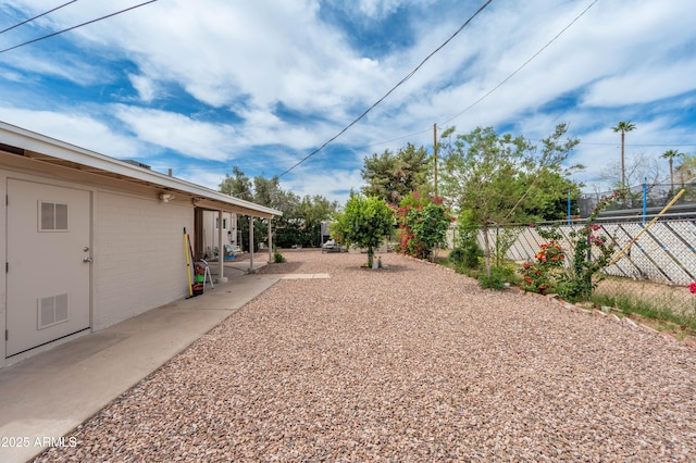 view of yard featuring a patio area, visible vents, and fence
