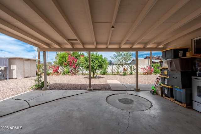 view of patio featuring an outdoor structure and fence