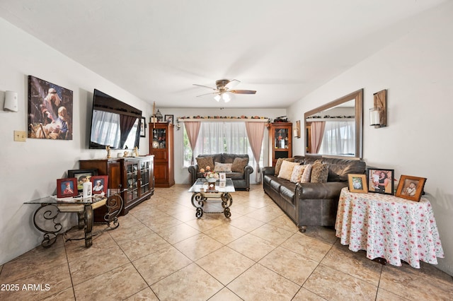 living area with a wealth of natural light, light tile patterned floors, and a ceiling fan