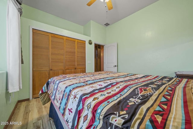 bedroom featuring a closet, visible vents, ceiling fan, light wood-type flooring, and baseboards