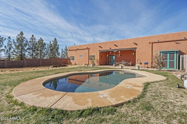 view of swimming pool with a yard, a patio area, a fenced backyard, and a fenced in pool