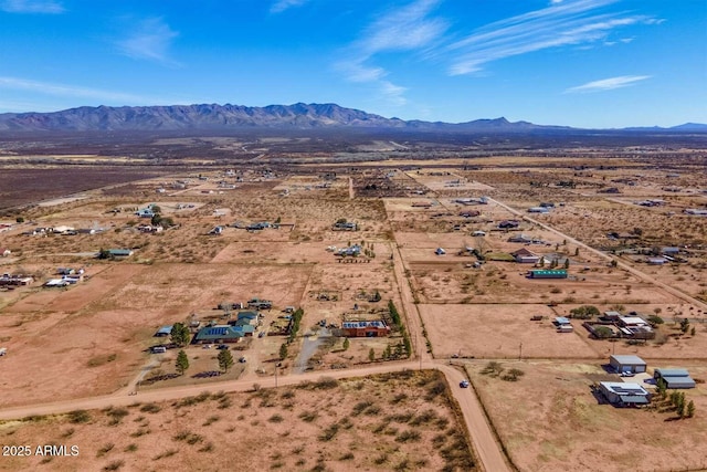 aerial view featuring a mountain view and view of desert