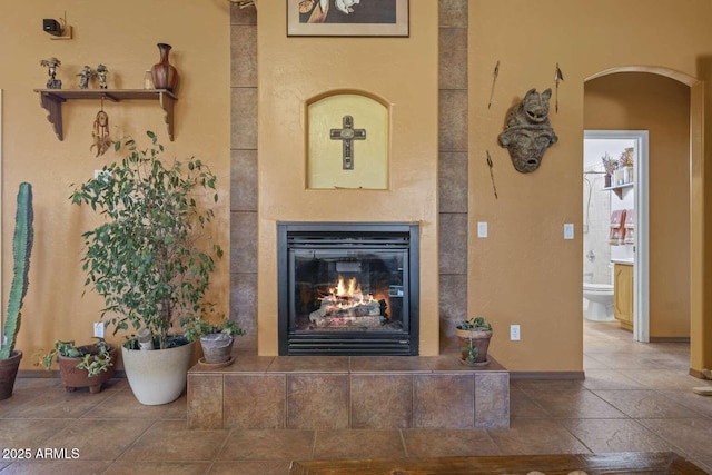 interior space with a tile fireplace