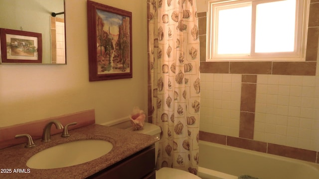 full bathroom with vanity, shower / bath combination with curtain, and toilet