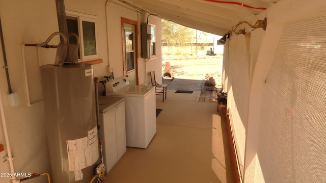 exterior space featuring washing machine and clothes dryer, electric panel, and water heater