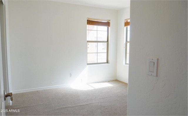 empty room with carpet floors and baseboards