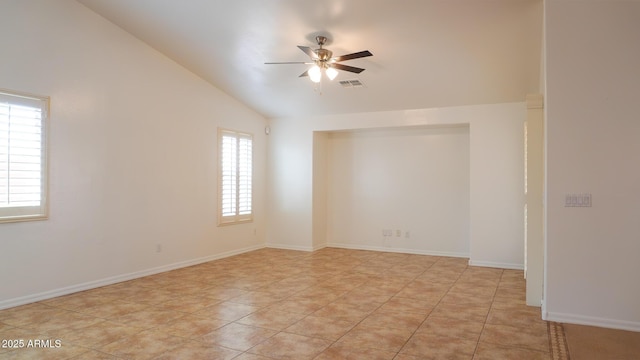 empty room with baseboards, visible vents, a ceiling fan, lofted ceiling, and light tile patterned flooring