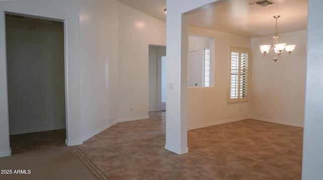 interior space with visible vents, a notable chandelier, and baseboards