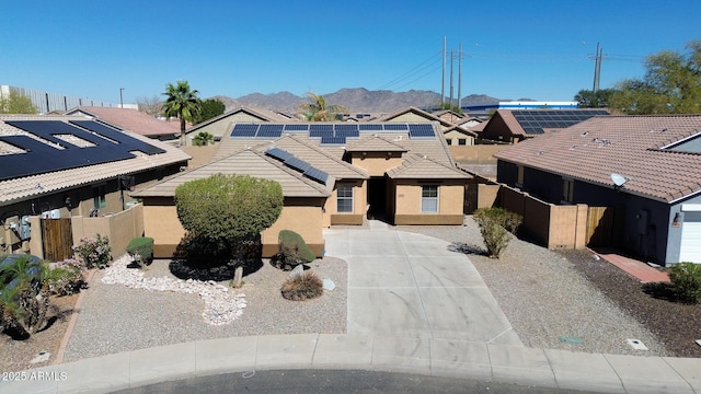 view of front facade with a residential view, a tile roof, fence, and stucco siding