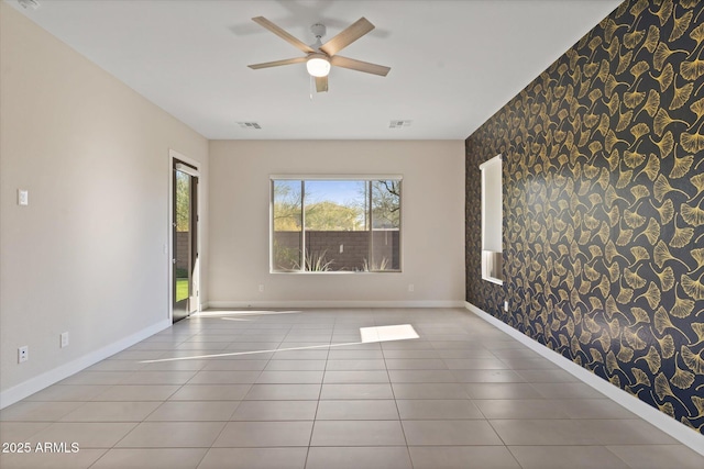 tiled spare room with a wealth of natural light and ceiling fan