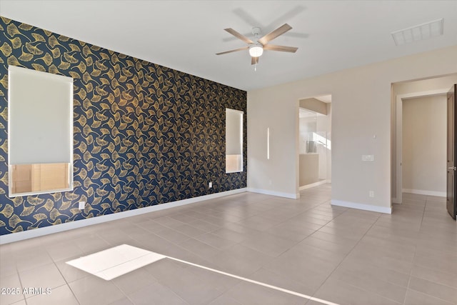 tiled spare room with ceiling fan