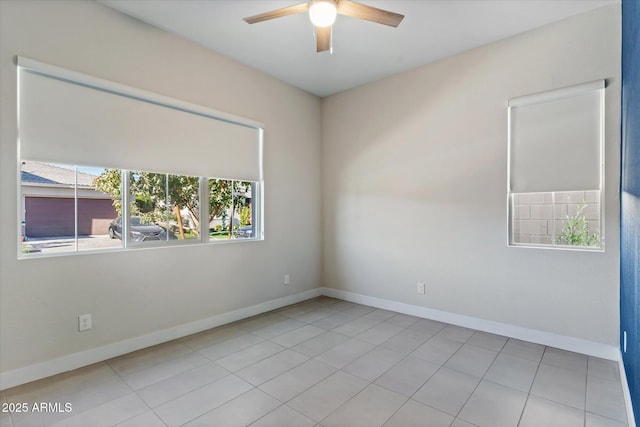 tiled spare room with ceiling fan